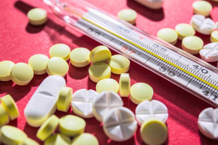 Medicamentos termolábeis ao lado de termômetro para controle de temperatura
